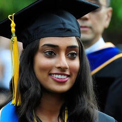 graduate wearing cap and gown at commencement