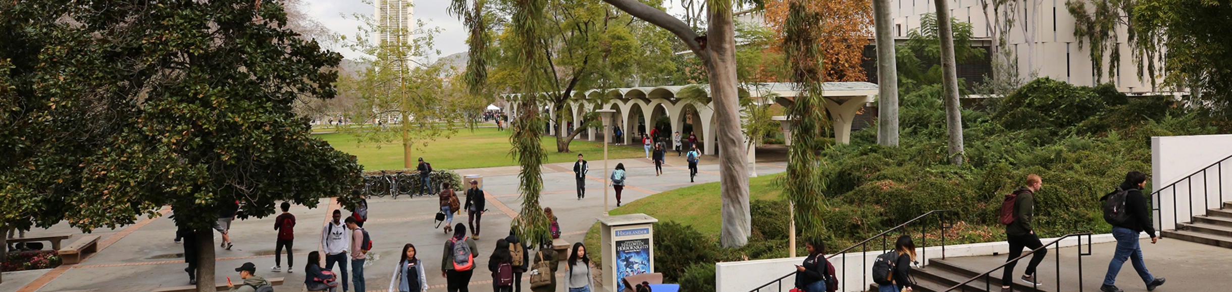 UCR Campus students walking Bell Tower in background (c) UCR/Stan Lim