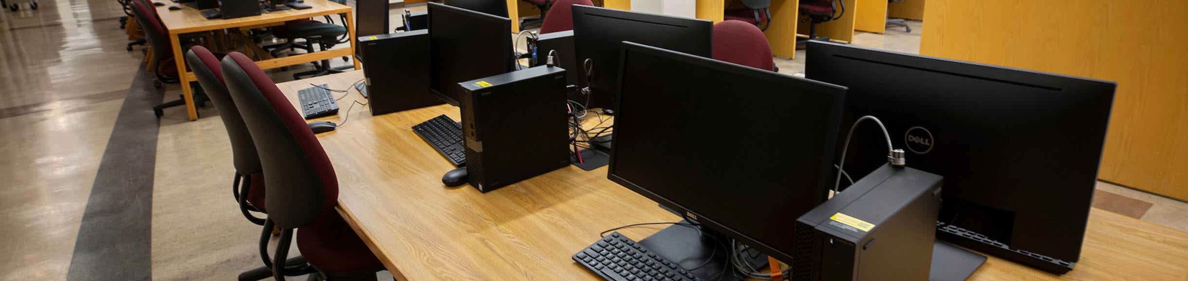 desktop computers on tables in library (c) UCR/Stan Lim