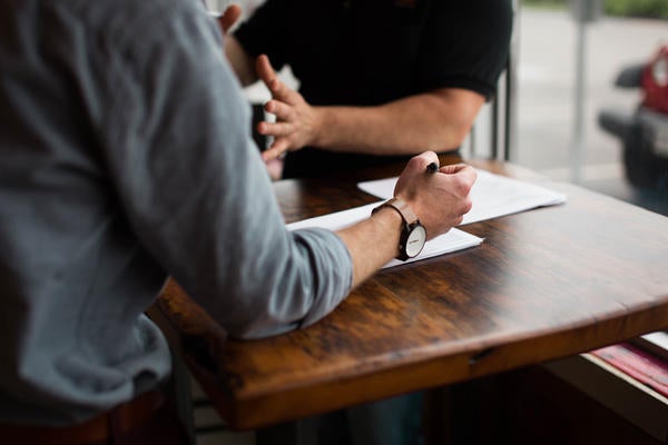 co-workers at a table (c) Nik Macmillan unsplash