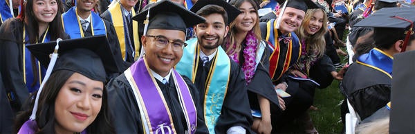 graduates in cap and gown at commencement (c) UCR/Stan Lim