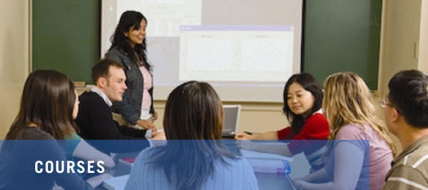 students and teacher at table in classroom